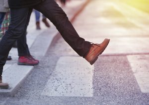 man stepping off the curb